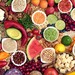 Verschiedene Früchte und andere vegane Lebensmittel zusammen auf einem Tisch drapiert und von oben fotografiert.
