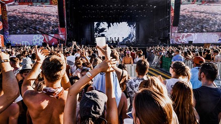 In Berlin ist festivaltechnisch für jede:n was dabei! (Foto: © stock.adobe.com/Marharyta Hanhalo) Sommerfestival, Sicht auf Bühne, davor leicht bekleidete Menschen am Feiern.