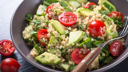 Avocado-Bowl in grauer Schale mit Gabel.